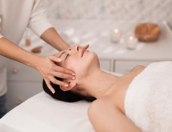 womanb receiving massage at spa